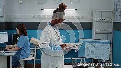 Woman working as doctor and holding digital tablet Stock Photo