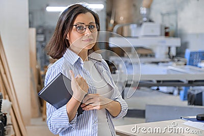 Woman working in carpentry, industrial portrait. Female in woodworking workshop Stock Photo