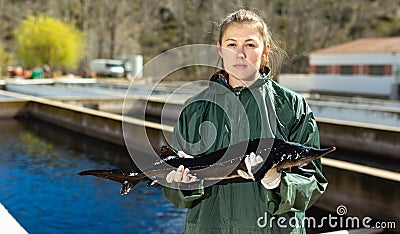 Woman holding sturgeon Stock Photo