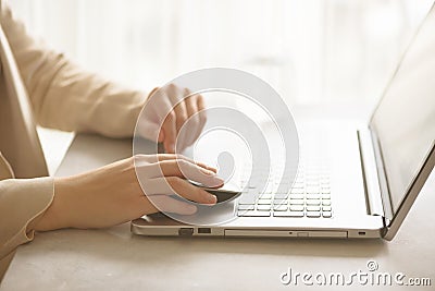 Woman working on computer close up. Woman hands typing on keyboard of laptop, online shopping detail. Business, remote Stock Photo