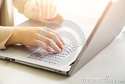 Woman working on computer close up. Woman hands typing on keyboard of laptop, online shopping detail. Business, remote Stock Photo