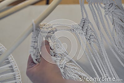 woman working on custom macrame decor with tools over a creative desktop watched from above. Hobby knitting macrame of Stock Photo