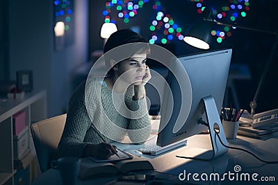 Woman working late at night Stock Photo