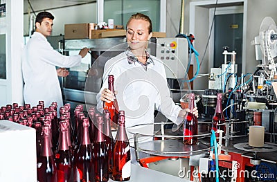 Woman working on wine production on manufactory Stock Photo