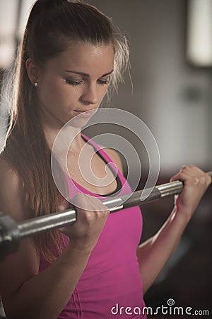 Woman workout in fitness gym with barbells - powerlift workout Stock Photo