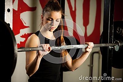 Woman workout in fitness gym with barbells - powerlift workout Stock Photo