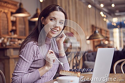 Woman works remotely online from cafe while quarantine coronavirus is in effect. Concept of checking mail, blogger, freelancer Stock Photo