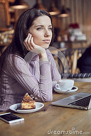 Woman works remotely online from cafe while quarantine coronavirus is in effect. Concept of checking mail, blogger, freelancer Stock Photo