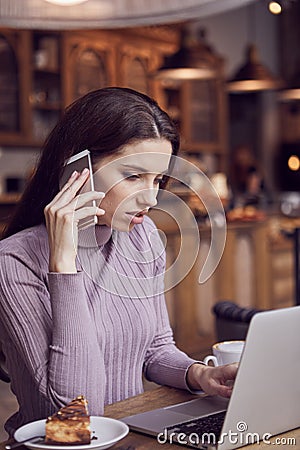 Woman works remotely online from cafe while quarantine coronavirus is in effect. Concept of checking mail, blogger, freelancer Stock Photo