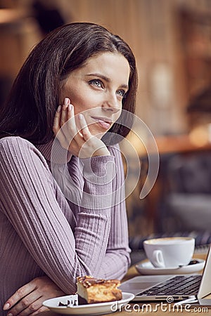 Woman works remotely online from cafe while quarantine coronavirus is in effect. Concept of checking mail, blogger, freelancer Stock Photo