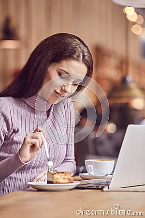 Woman works remotely online from cafe while quarantine coronavirus is in effect. Concept of checking mail, blogger, freelancer Stock Photo