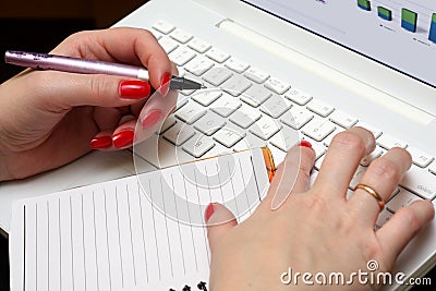 Woman works on a white laptop. Stock Photo