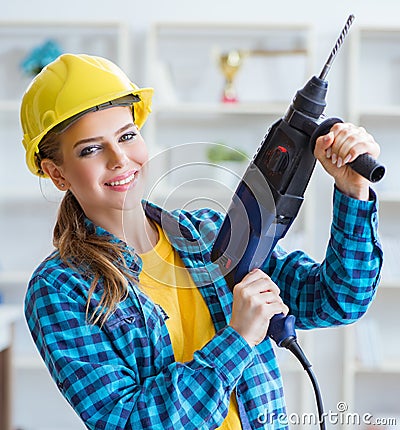 Woman in workshop with drilling drill Stock Photo