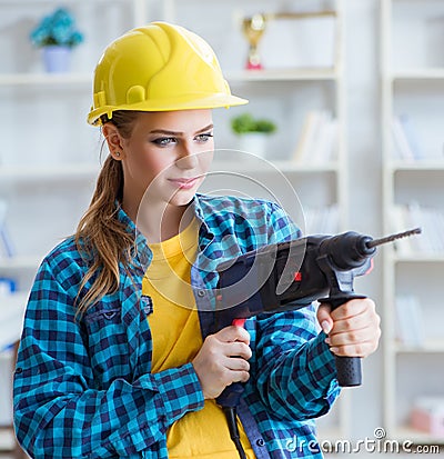 Woman in workshop with drilling drill Stock Photo