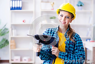 The woman in workshop with drilling drill Stock Photo