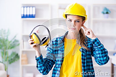 The woman in workshop with noise cancelling headphones Stock Photo