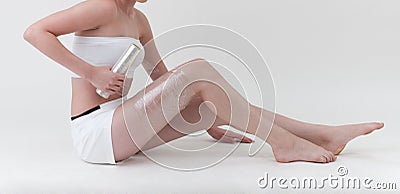 A woman wrapping her leg with plastic wrapper Stock Photo