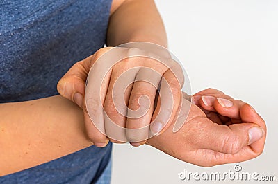 Woman with wrist pain is holding her aching hand Stock Photo