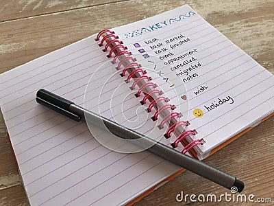 Bullet journal with a pen on a wooden desk Stock Photo