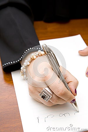 Woman writing note in Arabic Stock Photo