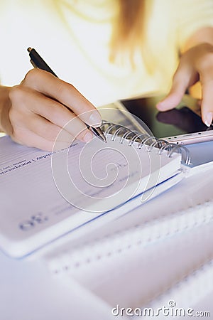 Woman is writing in the notebook Stock Photo