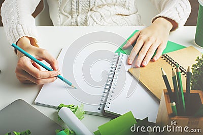 Woman writing in spiral notepad closeup Stock Photo