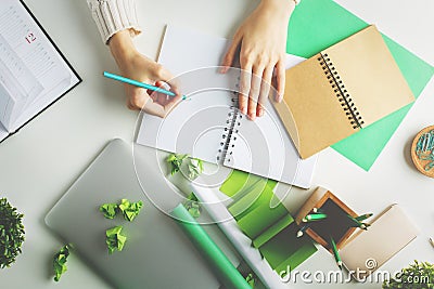 Woman writing in spiral notepad top Stock Photo