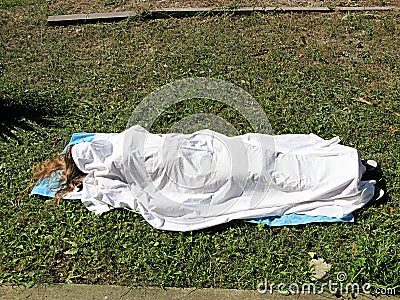 Woman's body under the bedsheet Stock Photo