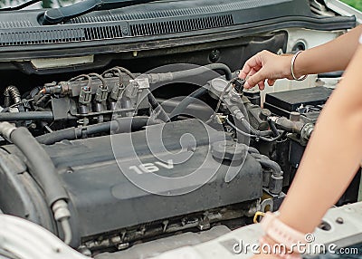 Woman& x27;s hand checking car engine before the trip Stock Photo