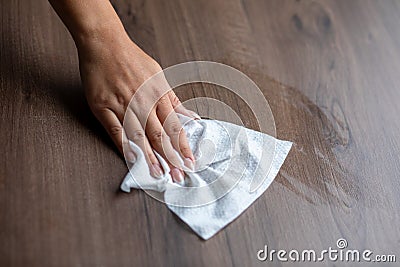 Woman cleaning home office table surface with wet wipes stock photo Stock Photo