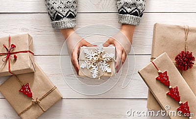 Woman's hands show christmas holiday present with craft twine Stock Photo