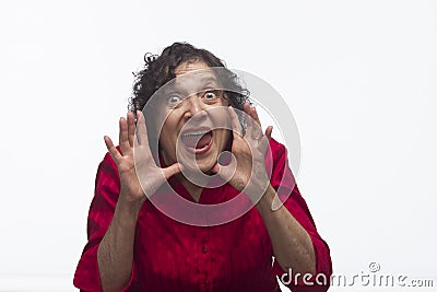 Woman yelling between hands, horizontal Stock Photo