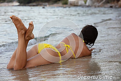 Woman in yellow bikini at beach Stock Photo