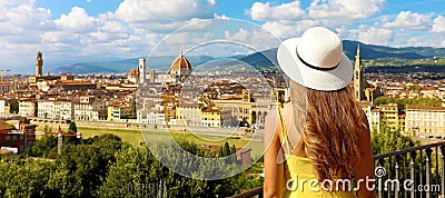 Woman in yellow dress and hat looks at stunning panoramic view of Florence, Italy. Happy pretty girl in Tuscany with Florence Stock Photo