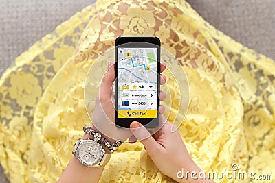 Woman in yellow dress holding phone with application call taxi Stock Photo