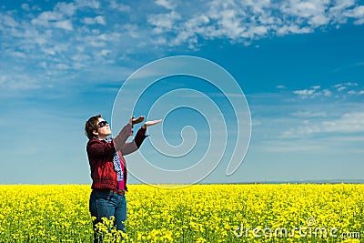 Woman in yellow field of rapeseed Stock Photo