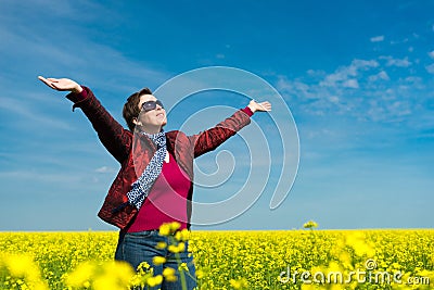 Woman in yellow field of rapeseed Stock Photo