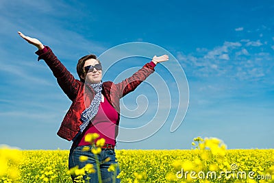 Woman in yellow field of rapeseed Stock Photo