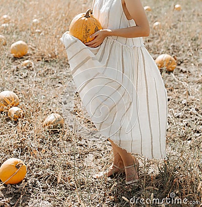 Woman yellow pumpkin holds hands subject Halloween Stock Photo