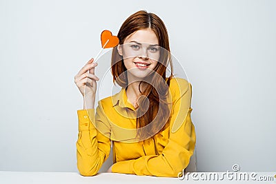 woman in yellow shirt lollipop heart charm lifestyle Stock Photo