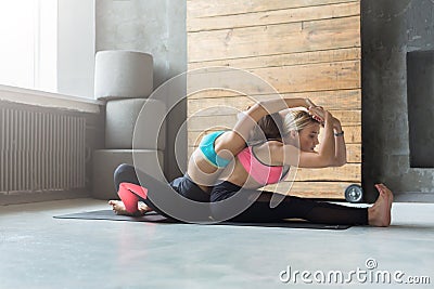 Woman with yoga instructor in class, back bend stretching Stock Photo