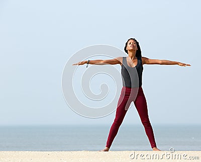 Woman yoga stretching at the beach Stock Photo