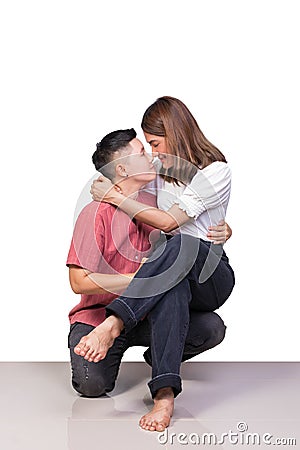 Woman young girls smiling and happiness sitting on knee of tomboy has tile floor with white background Stock Photo