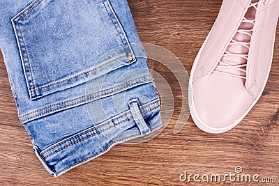 Womanly pink leather shoes and pants lying Stock Photo