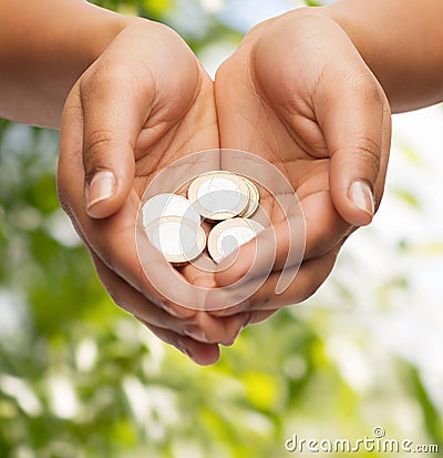 Womans cupped hands showing euro coins Stock Photo