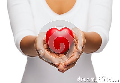 Womans cupped hands showing red heart Stock Photo