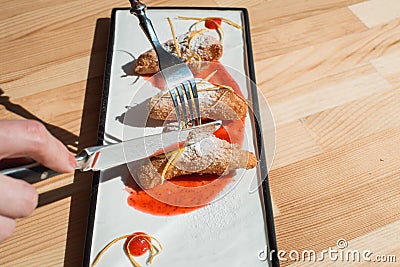 Spanish Leche Frita Dessert, decorated with jam close-up on a plate. Stock Photo