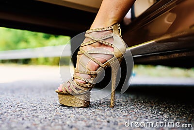 Womans legs in high heels. Luxury urban background. The woman is wearing shoes on high heels. Close up of woman legs Stock Photo