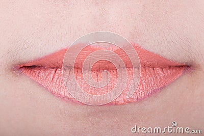 Womans lips with orange glossy lipstick Stock Photo