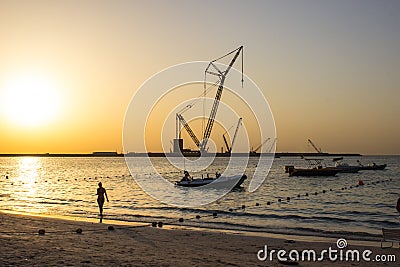 Womans silhouette at the beach sunset Editorial Stock Photo